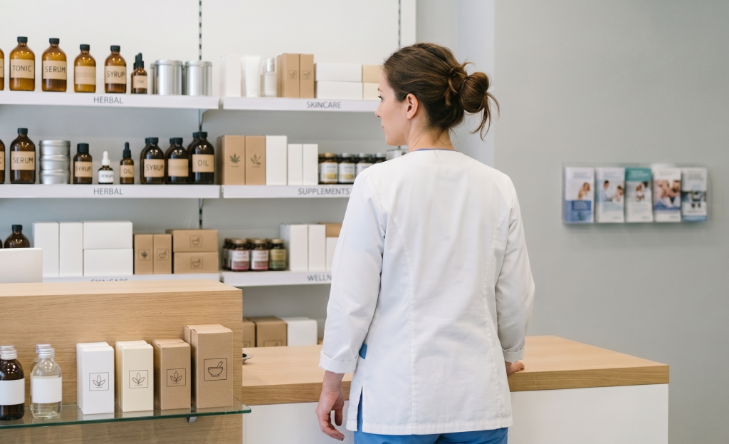 Female healthcare professional in a pharmacy or clinic, showcasing SMS Marketing solutions for medical centers and beauty salons by ProSMS.gr.